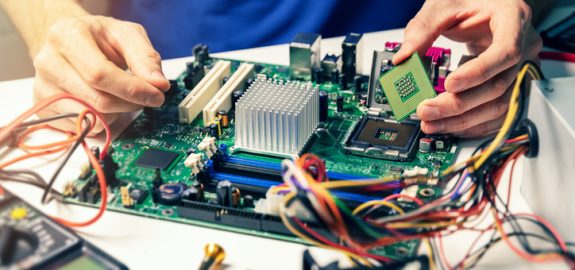 installing computer hardware - technician install CPU on motherboard
